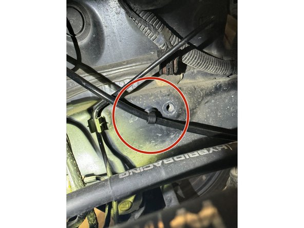 Route Hybrid Racing Clutch Line along frame rail and front of transmission case.