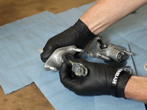 Pull the dust cover back on the EM1 CMC to expose the C-clip.