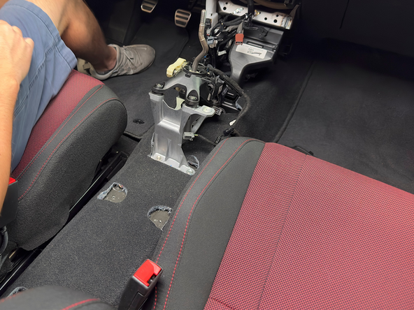 Slide the console backward and remove it from the car. It should be completely loose and free of all wires and bolts.