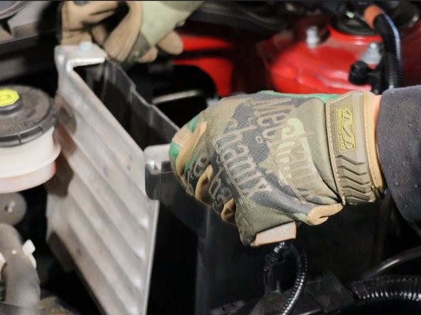 Remove the battery, heat shield and unbolt the lower battery tray.