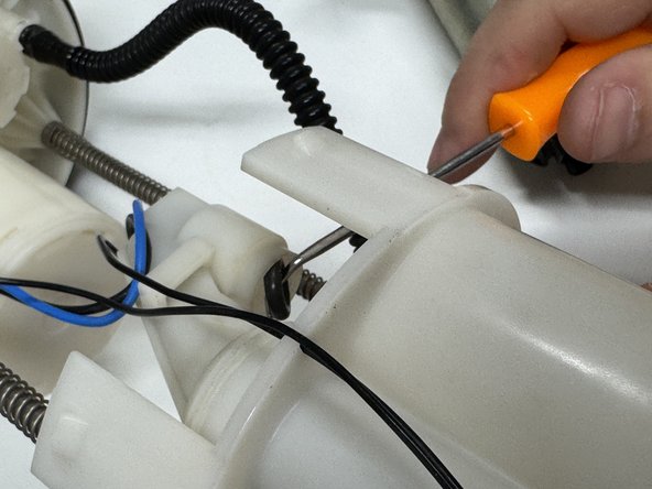 This is easy to do with a fine pick or flat tipped screwdriver.