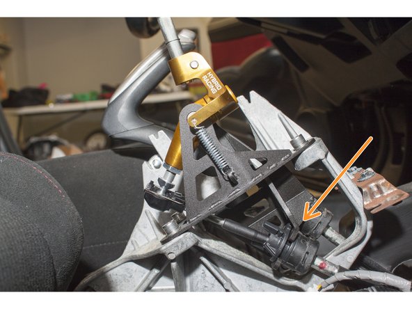If you are using Hybrid Racing shifter cables, use the supplied C-clips to secure the cables into the shifter base.