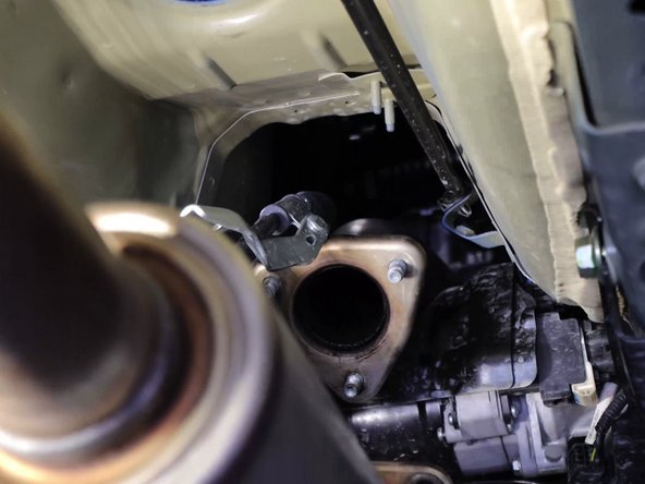 Slide the shifter cables out of the car. Be sure nothing gets caught up in the engine bay.