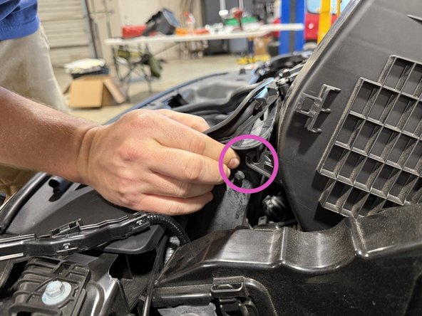 Remove the rubber inlet trim from the air cleaner cover. It stays in the car. You are just working it free to get the cover out, shown in the second photo.