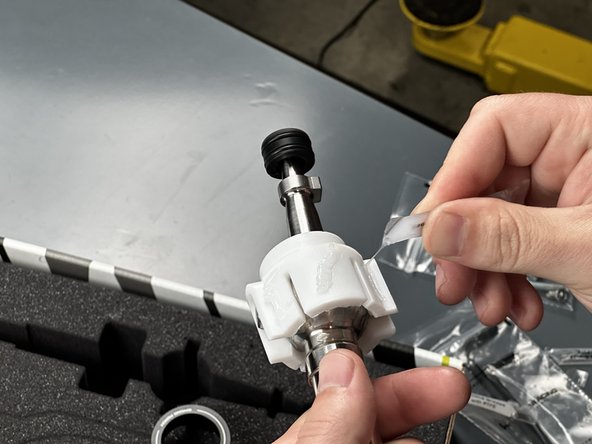 Use the last remaining packet of grease and apply it to the outside surface of the Shifter Pivot Seat. Be sure to leave enough grease for the next step.
