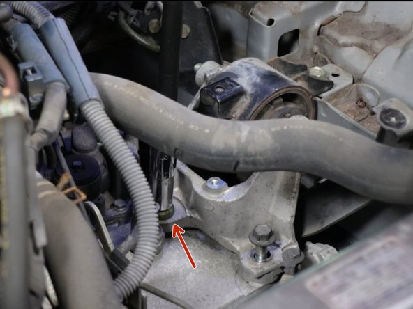 Remove the lower transmission bracket bolts.