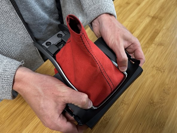 Reinstall the silver trim ring and clip it into place. Make sure all the fabric tabs are in place, and there are no gaps in the corners.