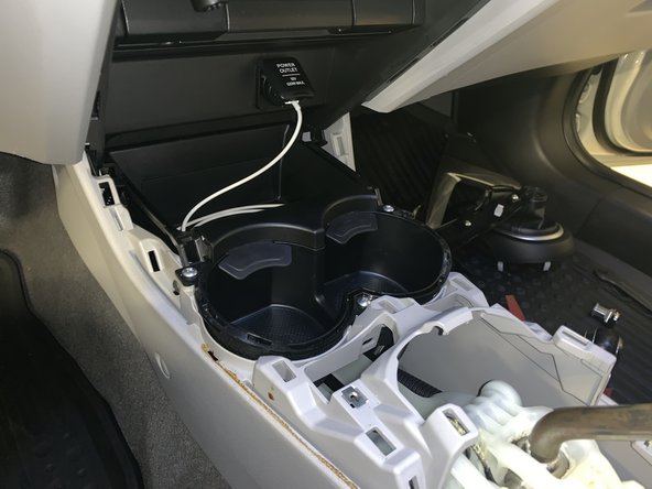 Using your hands, remove the side console trims. Once all of the screws have been removed, they just pop off.