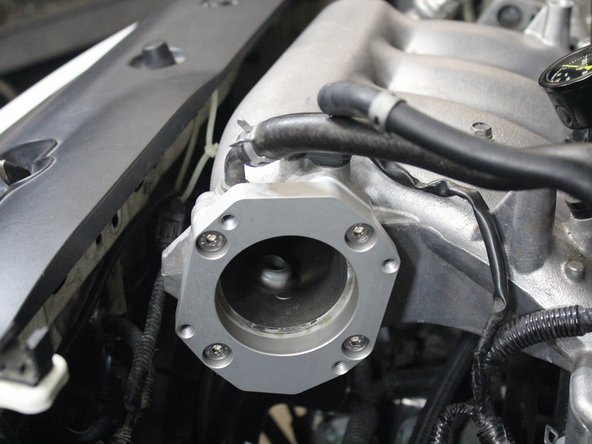 Use the shorter supplied bolts to mount the adapter to the intake manifold.
