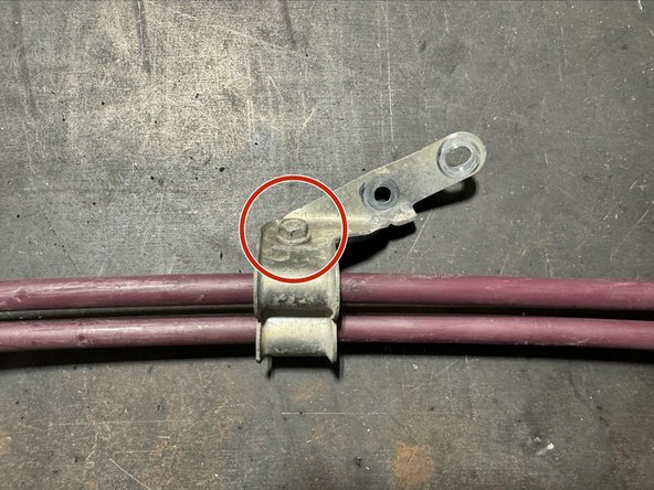 Remove the mounting bracket from OE cables. Use a 10mm socket to remove bolt.