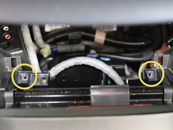 The lower coin pocked is held in with (x4) phillip screws. Two on top, two on the bottom. Remove all of them and the unplug the 12v socket on the back.