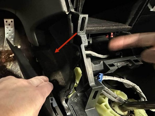 There are two panel clips here. Gently pull both sides until they release. Then move to the back of the car to finish the removal of the center console.