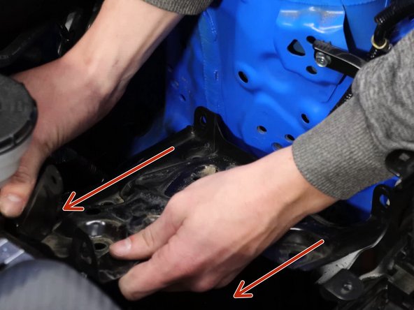 Once all of the bolts are removed, you'll need to slide the tray towards the engine and lift it out of the engine bay.
