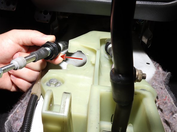 Once the clip is removed, push the cable inward and slide it away from the shifter.