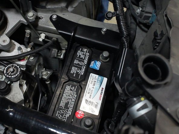 If you are using an aftermarket battery, some trimming of the upper battery case may be required.