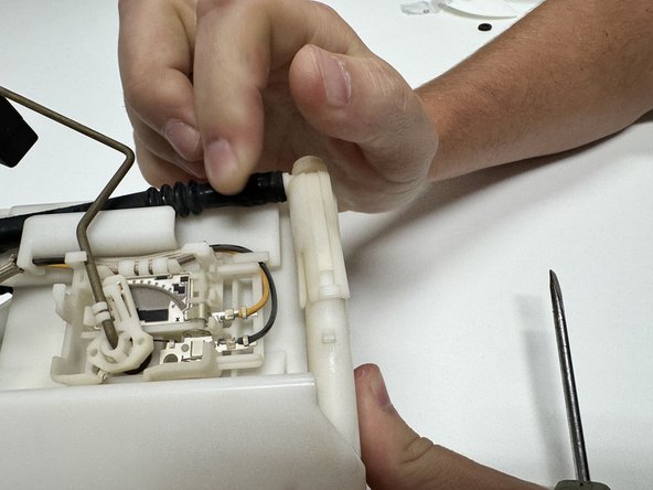 Unclip and disconnect the fuel pump hose. Remove it entirely so it does not interfere with the fuel level float.