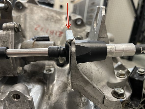 Then, install the cable through the transmission bracket. Secure with the supplied C clip.