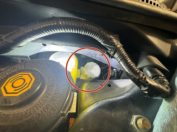 After Reservoir positioned on Strut Tower, tighten mounting bolt x1 M6x1.0, using 10mm socket.