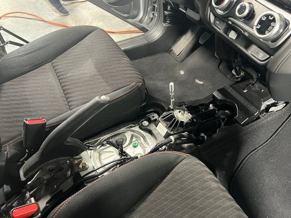 Slide it backward and lift the rear section upward.