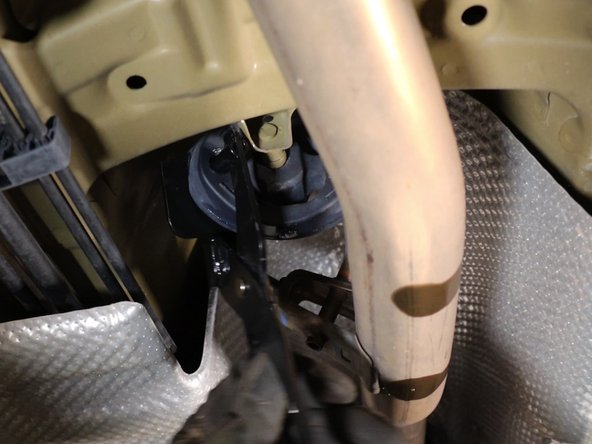 Remove the exhaust hanger. Spray lube helps the rubber slide easily.