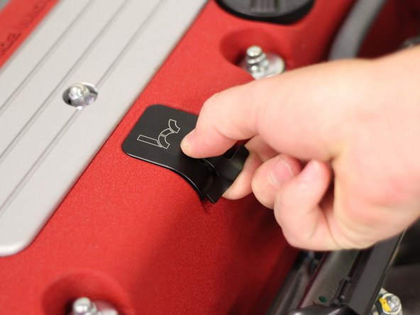 To unlock the dipstick, place your fingers under the latch and rotate it upwards. Once the latch is up, you will feel the assembly loosen.