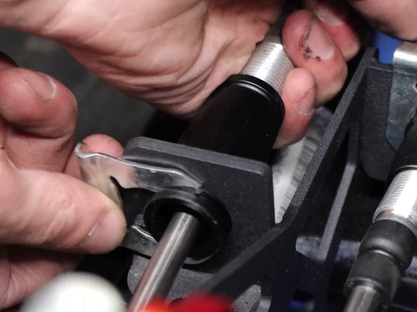 Now install the shifter cable retaining spring clips.