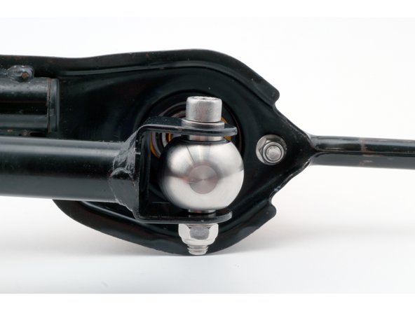 The lower linkage bearing should spin freely after being tightened.