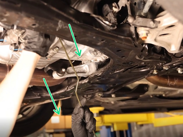 Remove the clutch line from the car. Removing it from under the car is easier as you won't have to bend it around the engine mount.