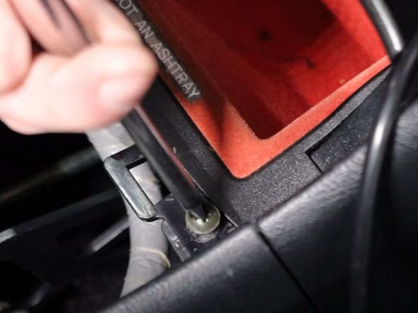 Remove all of the Phillips screws holding the console and coin pocket in place.