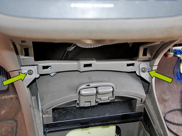 Using a Phillips head screwdriver remove the (2) screws closest to the front of the car.