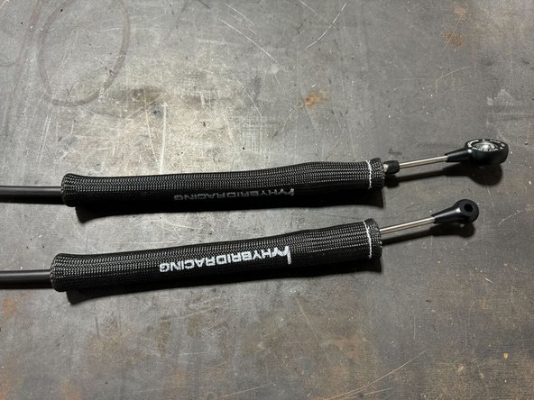 Tip: push over the cable bracket mounting bushings. This will hold heat-sleave in place while feeding cables through engine bay. (See 3rd image)