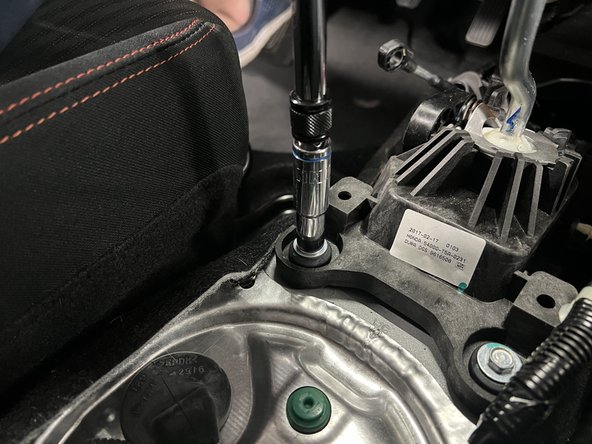 Remove the four shifter base mounting bolts.