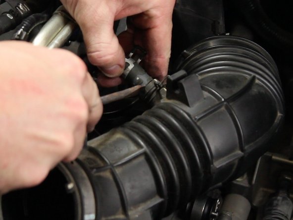 Unclamp and remove the air assist valve tube from the intake tube.