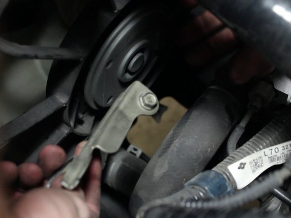 Remove the lower radiator hose bracket.