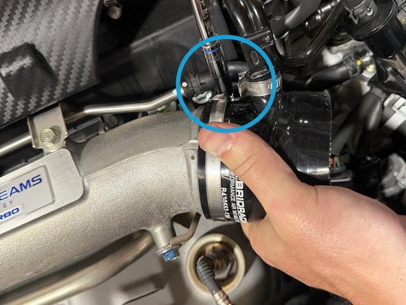 Insert the tube into the inlet and snug the clamp.