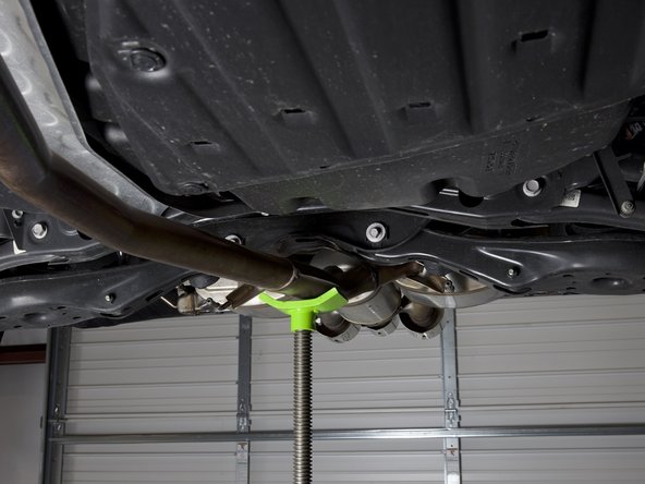 Use a jack, pole, wooden blocks, or a friend to support the exhaust system.