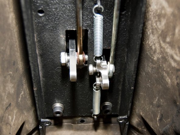 Slide the cable onto the retaining bolt before fully tightening.