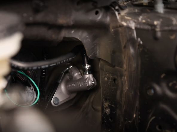 Install the reservoir hose to the new CMC and reinstall the clamp.