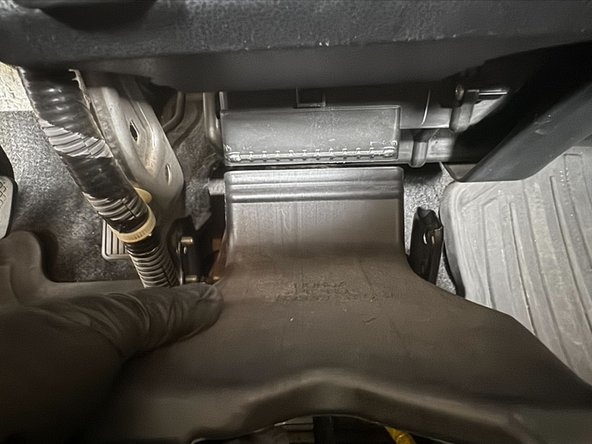 Reinstall the HVAC duct. Push up until the top of duct is level highlighted part of dashboard (Red Arrow)