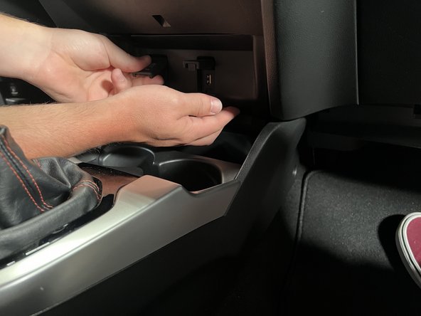 Pull it forward to release the clips.