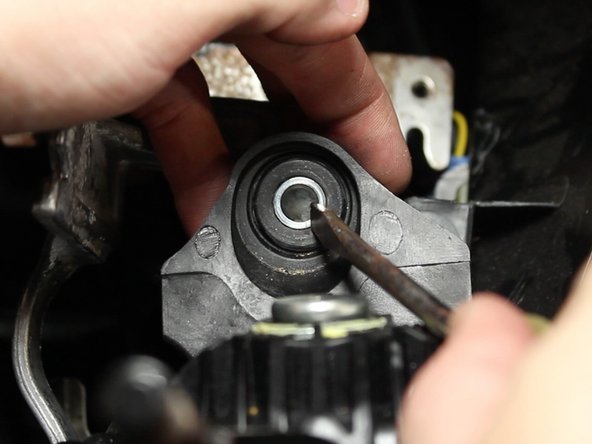 Push the metal base out of the rubber bushing.