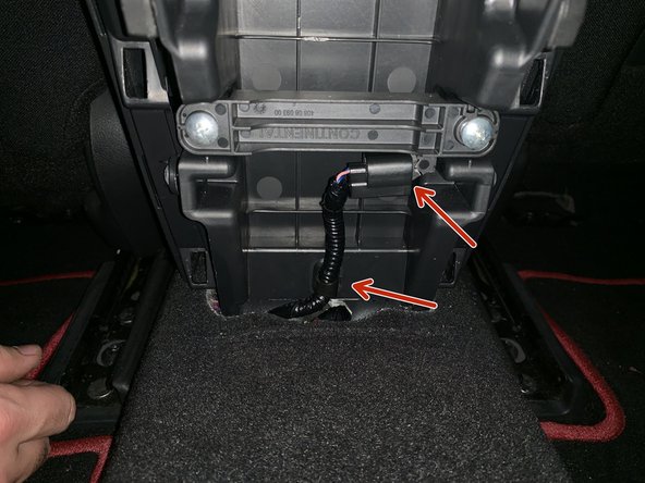 Once the cover comes off, unplug the keyless entry connector and remove the clip holding the harness in place.