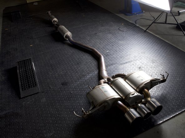 Pull downward to disconnect the exhaust and remove it from the car.