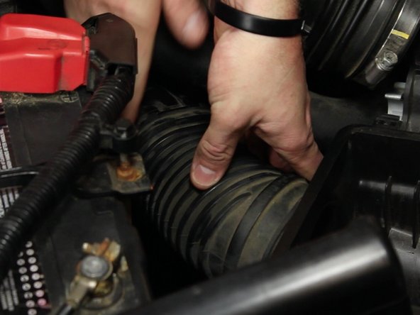 Disconnect the lower section of the air box from the resonator tube.