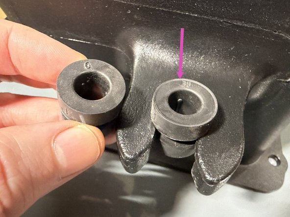 Install the rubber isolation grommet into the back of the intake. Make sure the ridge or lip on the grommet faces down, then insert the sleeve to hold it in place.