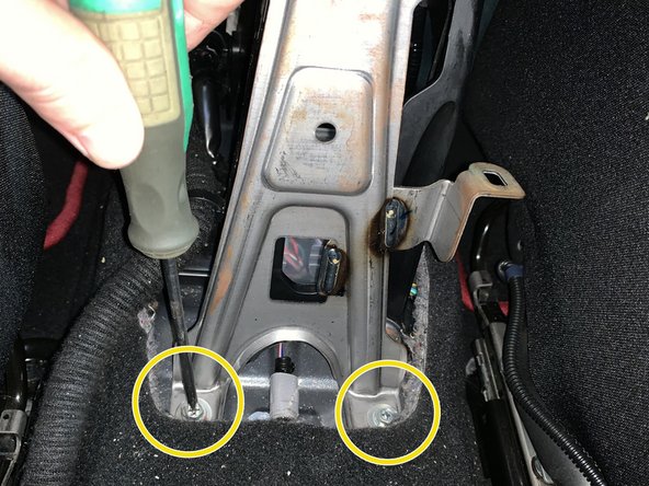 Remove the two bolts that hold the console bracket to the chassis.