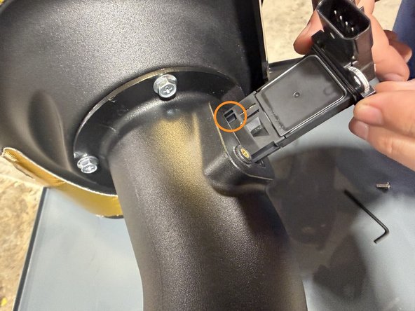 Insert the factory MAF sensor into the port on the Hybrid Racing intake tube, connector facing up like in the second image.