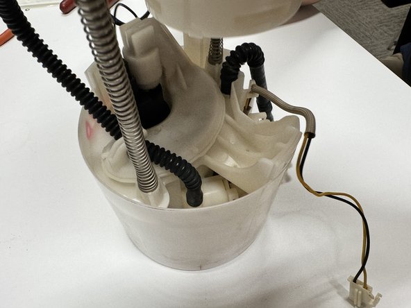 Slide the pump assembly into the housing. Be sure to secure all clips around the top of the case.