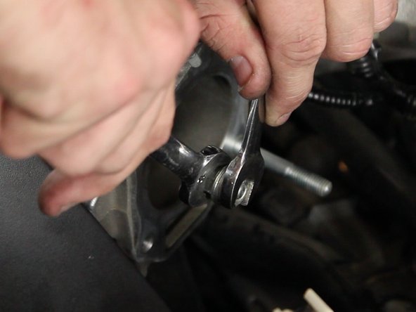 Use the two 12mm nuts that held the throttle body in place and place them face to face, as shown in the picture.