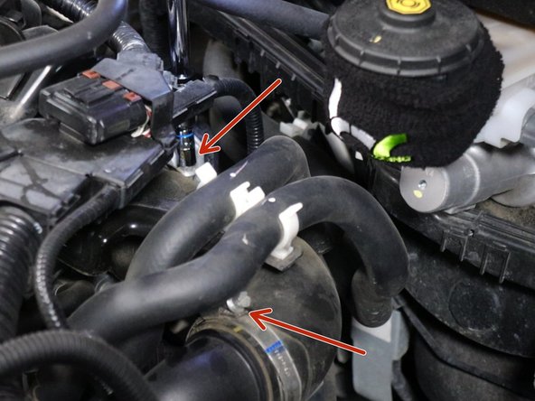 Loosen the air inlet tube and remove it. Be sure to move the hoses out of the way.